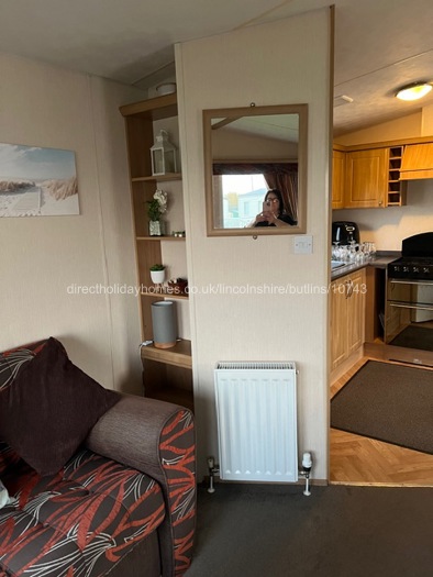 Part of lounge with kitchen entry