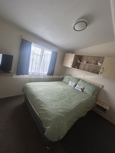 Spacious main bedroom with tv