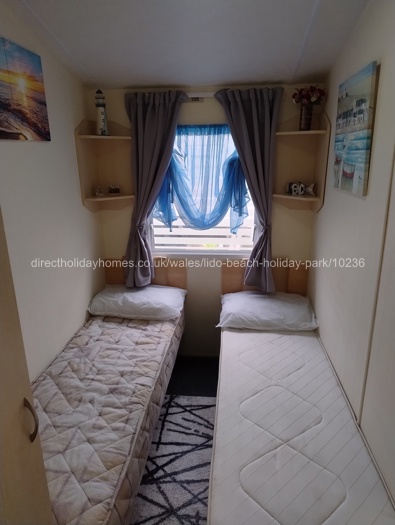 Two single beds with shelving
