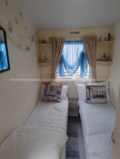 Two single beds with shelving