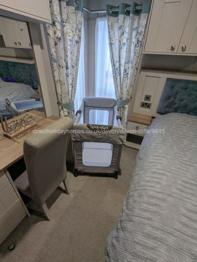 Master bedroom with travel cot set 